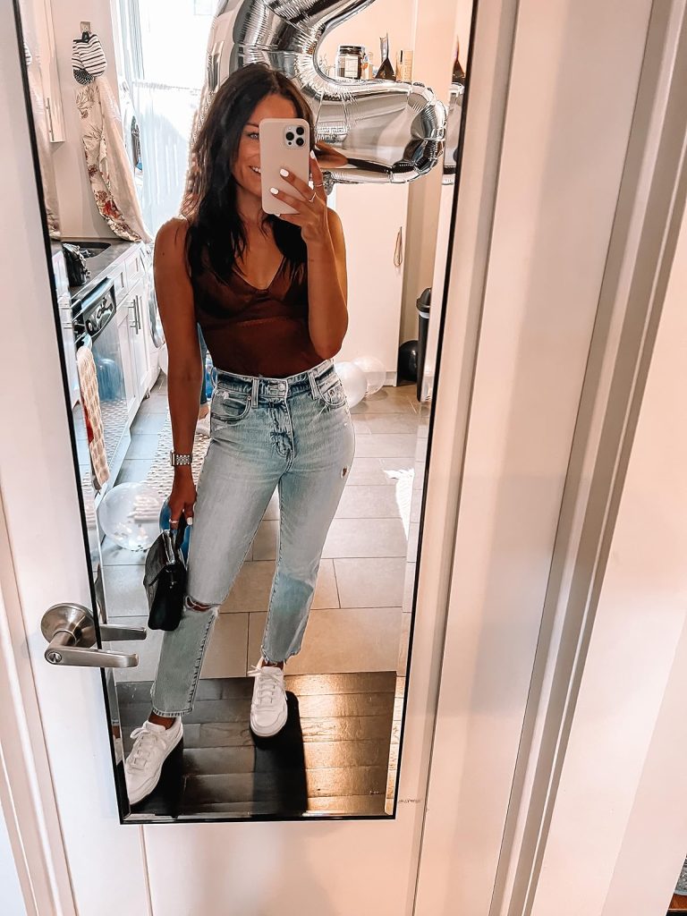 NYC outfit: Brown Satin Corset Bodysuit, Lighwash Jeans, White Sneakers, and a Black Snakeskin Purse