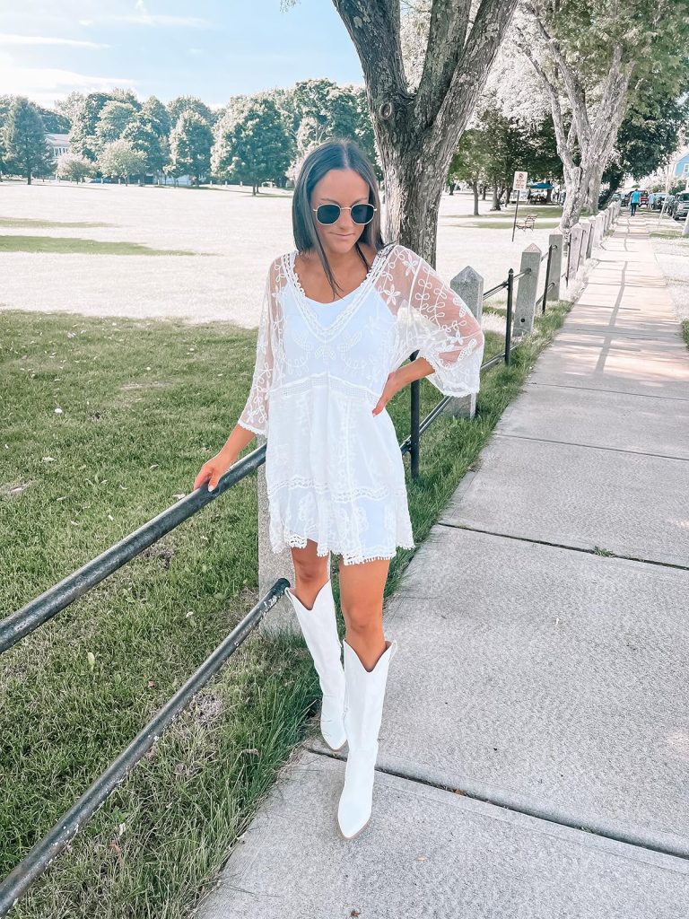 White dress, white lace cover-up, and white knee-high boots