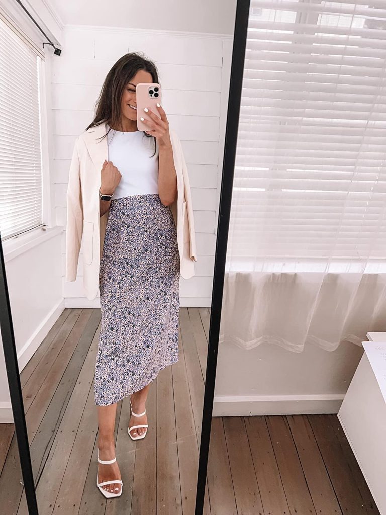 white halter top with a floral midi skirt and cream-colored blazer