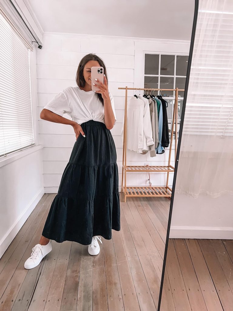 tied white t-shirt with a black maxi dress and sneakers